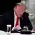 Then US President Donald Trump looks at his phone during a roundtable with governors on the reopening of America's small businesses, at the White House in Washington DC, USA on June 18, 2020