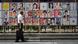 A man walks past placards ahead of the election in Tokyo, Japan A man walks past placards ahead of the election in Tokyo, Japan