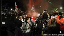 Protesters and journalists at a demonstration in Tblisi