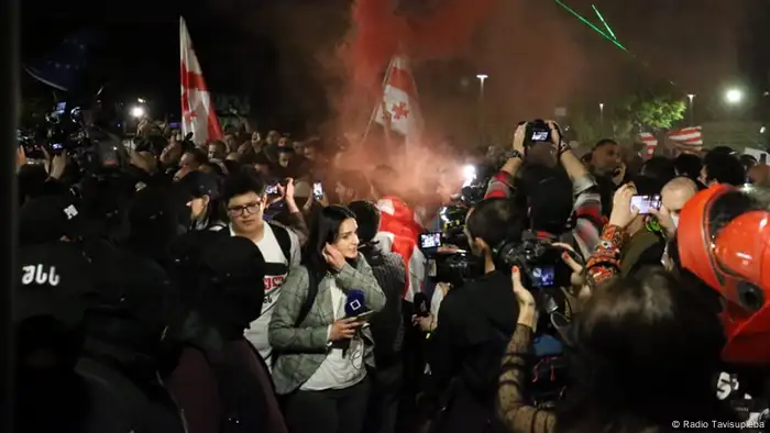 Protesters and journalists at a demonstration in Tblisi