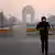 A man wears a face mask as he jogs in the early morning smog in New Delhi