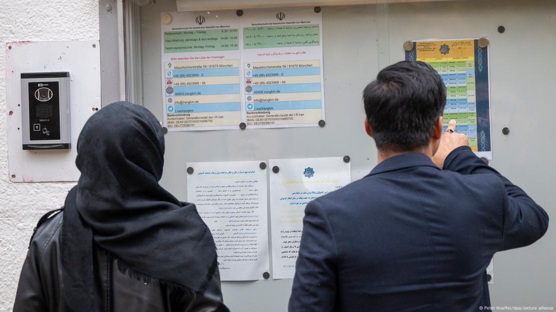 Eine Frau und ein Mann stehen vor dem iranischen Generalkonsulat in München