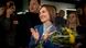 Moldovan President Maia Sandu clapping and holding flowers after winning presidential runoff with supporters standing behind her Moldovan President Maia Sandu clapping and holding flowers after winning presidential runoff with supporters standing behind her