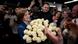 Moldovan President Maia Sandu beams as she is given an enormous bouquet of white roses. She is surrounded by people smiling, clapping and taking photos on their smartphones and a journalist with a television camera Moldovan President Maia Sandu beams as she is given an enormous bouquet of white roses. She is surrounded by people smiling, clapping and taking photos on their smartphones and a journalist with a television camera