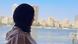 A woman in a headscarf looks at Cairo's skyline A woman in a headscarf looks at Cairo's skyline