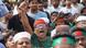 A protester wearing Bangladeshi national colors raises his fist during a march in Dhaka A protester wearing Bangladeshi national colors raises his fist during a march in Dhaka