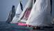 A row of sailboats at the start of the Vendee race A row of sailboats at the start of the Vendee race
