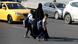 An Iraqi woman walks with her children back from school in central Baghdad on November 19, 2024. An Iraqi woman walks with her children back from school in central Baghdad on November 19, 2024.