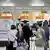 Passengers gather near check-in counters at Narita International Airport in Narita, east of Tokyo