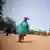 A woman in Niamey, Niger carrying an aid package on her head that was donated by Turkey on of the nations outside the EU also providing assistance to Niger 