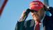 Donald Trump puts on a MAGA hat during the US election campaign Donald Trump puts on a MAGA hat during the US election campaign