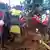 Uganda Red Cross workers search for bodies after a landslide following heavy rains buried 40 homes in the mountainous district of Bulambuli, eastern Uganda