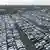 Aerial photo of thousands of unsold new cars waiting at a distribution center in Essen, western Germany. November 29, 2024. The cars are of various makes, but include multiple recognizable Volkswagens.