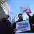 A protester with a sign reading "Arrest Yoon Suk Yeol" at a rally in Seoul on Wednesday morning