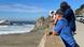 People watch waves coming into the beach in San Francisco People watch waves coming into the beach in San Francisco