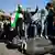 Students stand on the toppled statue of the late Syria's President Hafez al-Assad, father of Bashar al-Assad, after Syria's Bashar al-Assad was ousted, in Damascus, Syria, December 15, 2024.