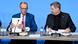 Friedrich Merz y Markus Söder ante una mesa con dos botellas de agua cada uno y sendos micrófonos. Merz sostiene sus papeles de forma vertical. Friedrich Merz y Markus Söder ante una mesa con dos botellas de agua cada uno y sendos micrófonos. Merz sostiene sus papeles de forma vertical.