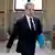 Man walking with folder under his arm