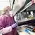 A lab worker prepares a test tube rack of milk samples for testing.