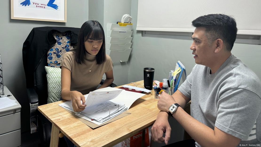 Dr. Jeremy Jordan Castro, medical officer, talks with peer educator Raymond Brigino at the Klinika Eastwood HIV and sexually transmitted infection (STI) testing center