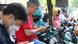 Men use their smartphone as they sit on their motorbike in Ho Chi Minh City on December 23 Men use their smartphone as they sit on their motorbike in Ho Chi Minh City on December 23