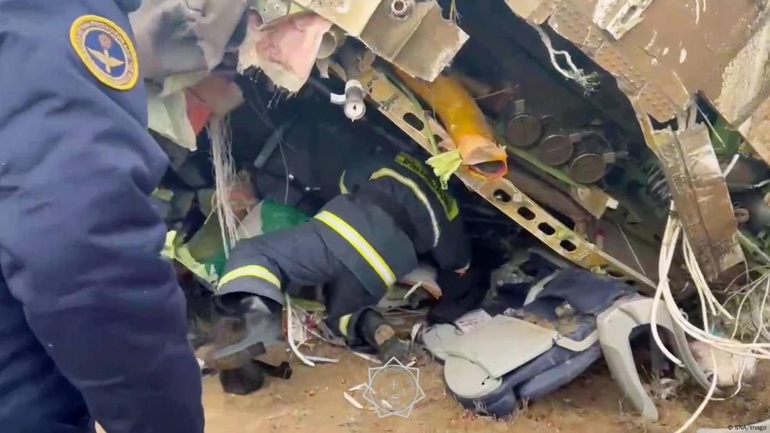 Eine Rettungskraft klettert in das Flugzeugwrack nach dem Flugzeugabsturz