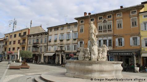 Një shesh me shatërvan me skluptura në qendër të qytetit Gorizia në Itali
