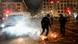 Police officers stamp out the fire in the streets after the fireworks for the New Year's celebrations in Berlin, Germany, Police officers stamp out the fire in the streets after the fireworks for the New Year's celebrations in Berlin, Germany,