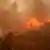 A firefighter battles flames in the Pacific Palisades neighborhood of Los Angeles, California