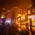 A firefighter battles the Palisades Fire while it burns homes at Pacific Coast Highway amid a powerful windstorm on January 8, 2025 in Los Angeles, California