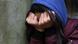 A file photo shows a girl with hood up and hands covering her face A file photo shows a girl with hood up and hands covering her face