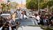 Emmanuel Macron waves from an open car, standing in front of Guinea-Bissau's President Umaro Sissoco Embalo Emmanuel Macron waves from an open car, standing in front of Guinea-Bissau's President Umaro Sissoco Embalo