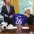 Donald Trump holds up a soccer shirt with his name on in the Oval Office, while Gianni Infantino looks on