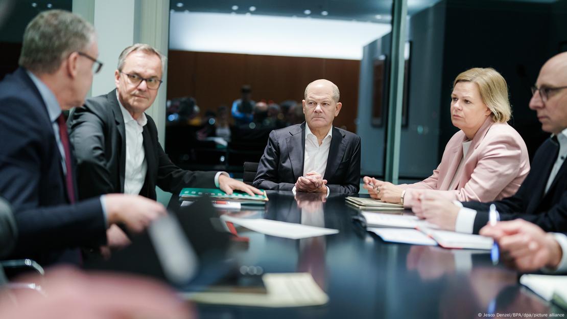 German Chancellor Olaf Scholz and Interior Minister Nancy Faeser listen as security chiefs brief them following a stabbing in Bavaria. 