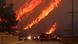 Flames rise behind vehicles as the Hughes Fire burns in Castaic Lake, California, US January 22, 2025 Flames rise behind vehicles as the Hughes Fire burns in Castaic Lake, California, US January 22, 2025