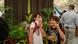 A child covers their nose with their T-shirt near a corpse flower exhibit inside a greenhouse. A child covers their nose with their T-shirt near a corpse flower exhibit inside a greenhouse.