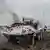 A UN armoured personnel carrier burns during clashes with M23 rebels outside Goma