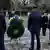 German Interior Minister Nancy Faeser and Bavarian state premier Markus Söder stand before wreaths in Aschaffenburg