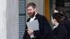 Lawyer in robes seen talking before a building Lawyer in robes seen talking before a building