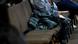 A person sitting on chair with jacket at immigration workshop at church A person sitting on chair with jacket at immigration workshop at church