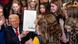 Donald Trump holding up a signed executive order surrounded by young girls in the White House on February 5, 2025 Donald Trump holding up a signed executive order surrounded by young girls in the White House on February 5, 2025