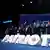 Men and women clap as they stand on a stage in front of a blue backdrop with Spanish words and behind the word 'Patriots' spelled out in large white letters. Madrid, Spain, February 8, 2025