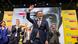 Christian Lindner waving happily infront of clapping FDP representatives and a campaign poster showing his face Christian Lindner waving happily infront of clapping FDP representatives and a campaign poster showing his face