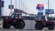 Two tractors, one with a very large Serbian flag attached to it, are parked across the lanes of a highway in the Serbian capital, Belgrade, blocking the road. Behind the tractors, a little way off, the road is full of people, some on motorbikes Two tractors, one with a very large Serbian flag attached to it, are parked across the lanes of a highway in the Serbian capital, Belgrade, blocking the road. Behind the tractors, a little way off, the road is full of people, some on motorbikes