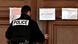 Policeman closes door of courtroom bearing the sign 'closed door' (Huit clos) Policeman closes door of courtroom bearing the sign 'closed door' (Huit clos)