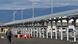 Para pekerja berjalan melewati atap panel surya yang dipasang di terminal bus di lokasi Osaka Expo 2025, 17 Januari 2025 Para pekerja berjalan melewati atap panel surya yang dipasang di terminal bus di lokasi Osaka Expo 2025, 17 Januari 2025