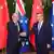 Cook Islands Mark Brown shakes hands with Chinese Premier Li Qiang in front of flags