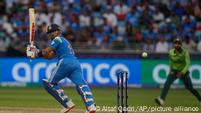 Virat Kohli flicks a ball to the leg side as Pakistan's wicketkeeper looks on Virat Kohli flicks a ball to the leg side as Pakistan's wicketkeeper looks on