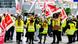 Striking workers hold the flags of the trade union Verdi at Dusseldorf airport, Germany Striking workers hold the flags of the trade union Verdi at Dusseldorf airport, Germany