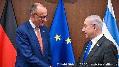 Friedrich Merz and Benjamin Netanyahu shaking hands before flags (2024)